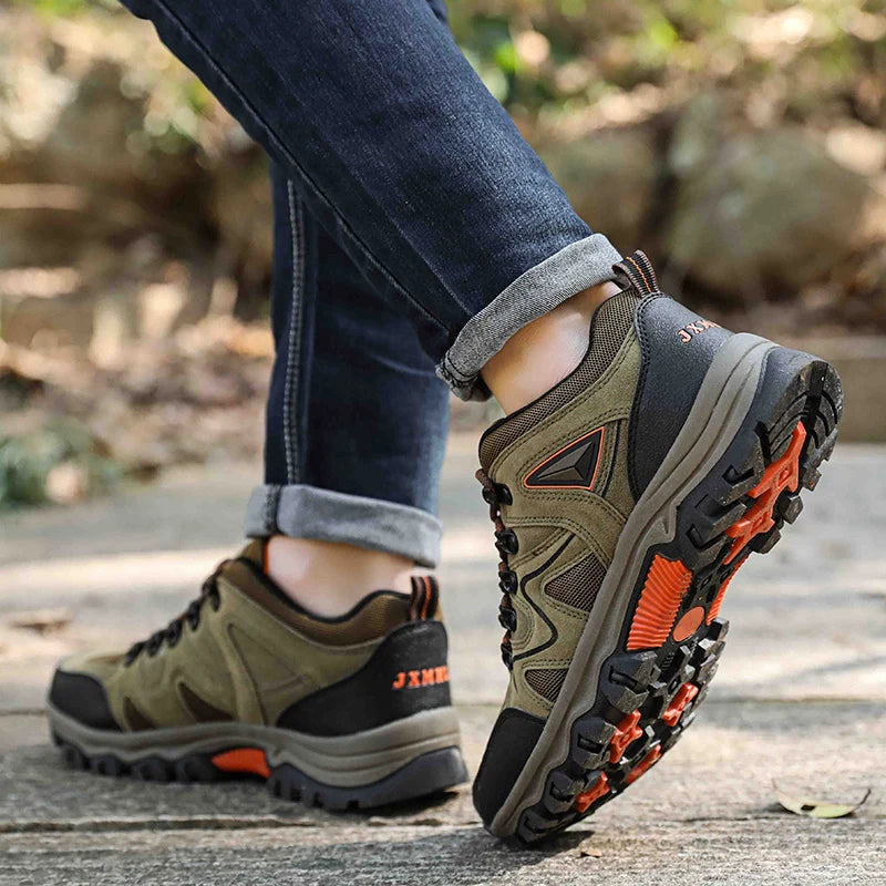 Hiking shoes with orange accents worn outdoors on a blurred natural background
