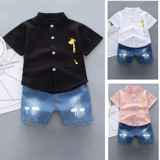 Children's clothing set with black shirt, white shirt, and pink shirt on a gray background.