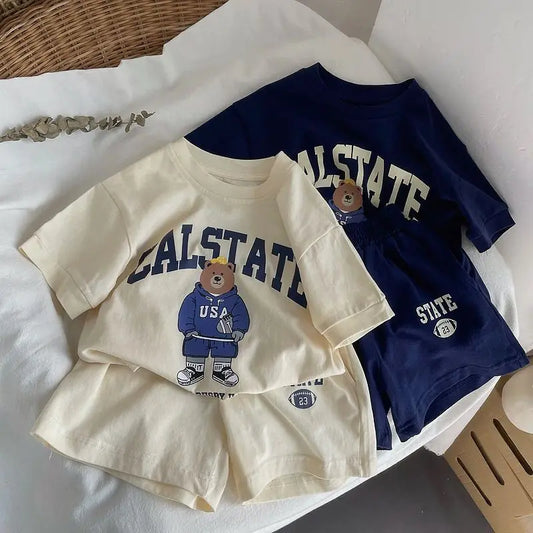 Children's clothing set with 'CALSTATE' design on a white surface