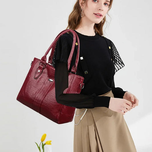 Woman holding a red handbag against a white background