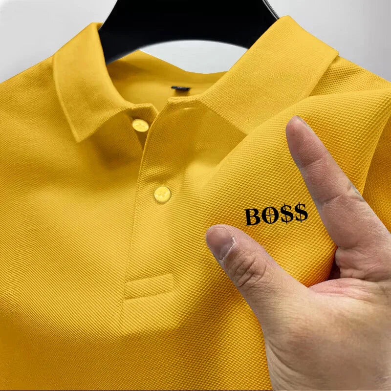 Yellow polo shirt with 'BOSS' text on a hanger, finger pointing at the text.