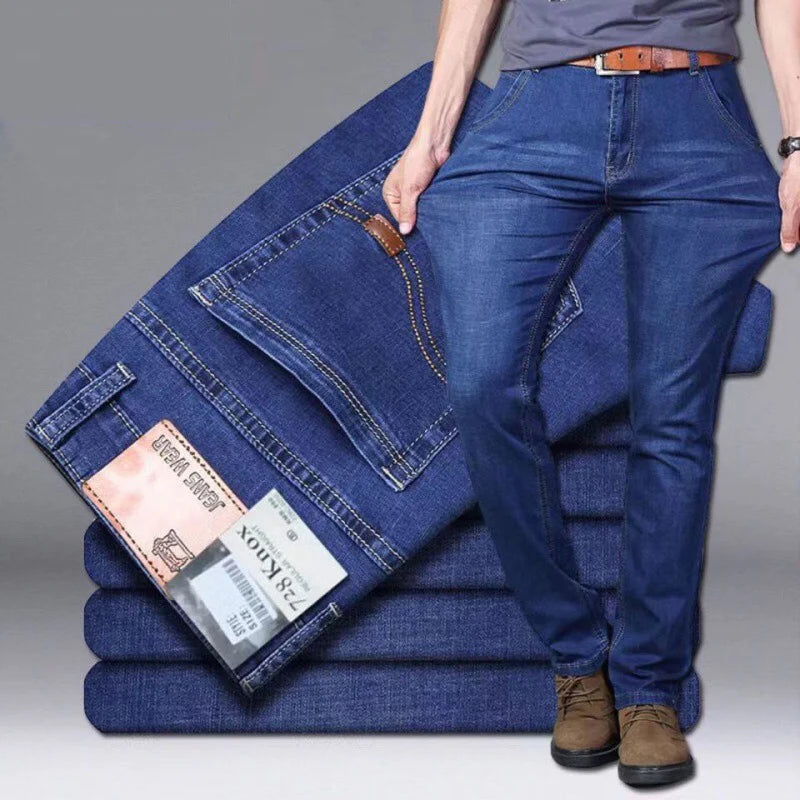 Stack of blue jeans with a person wearing them on a gray background
