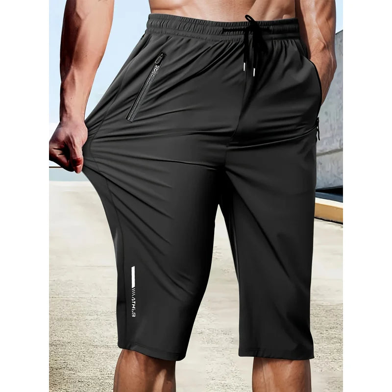 Black athletic shorts with a drawstring on a neutral background