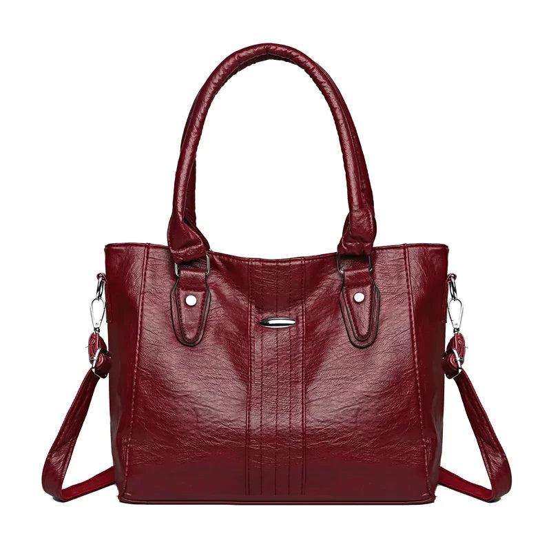 Red handbag with a strap on a white background