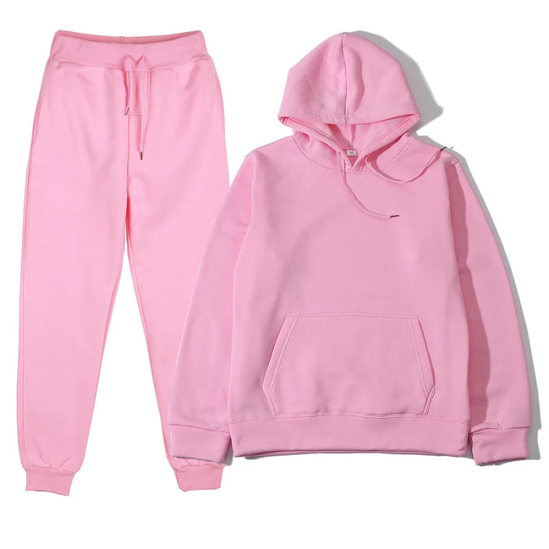 Pink hoodie and pants set on a white background