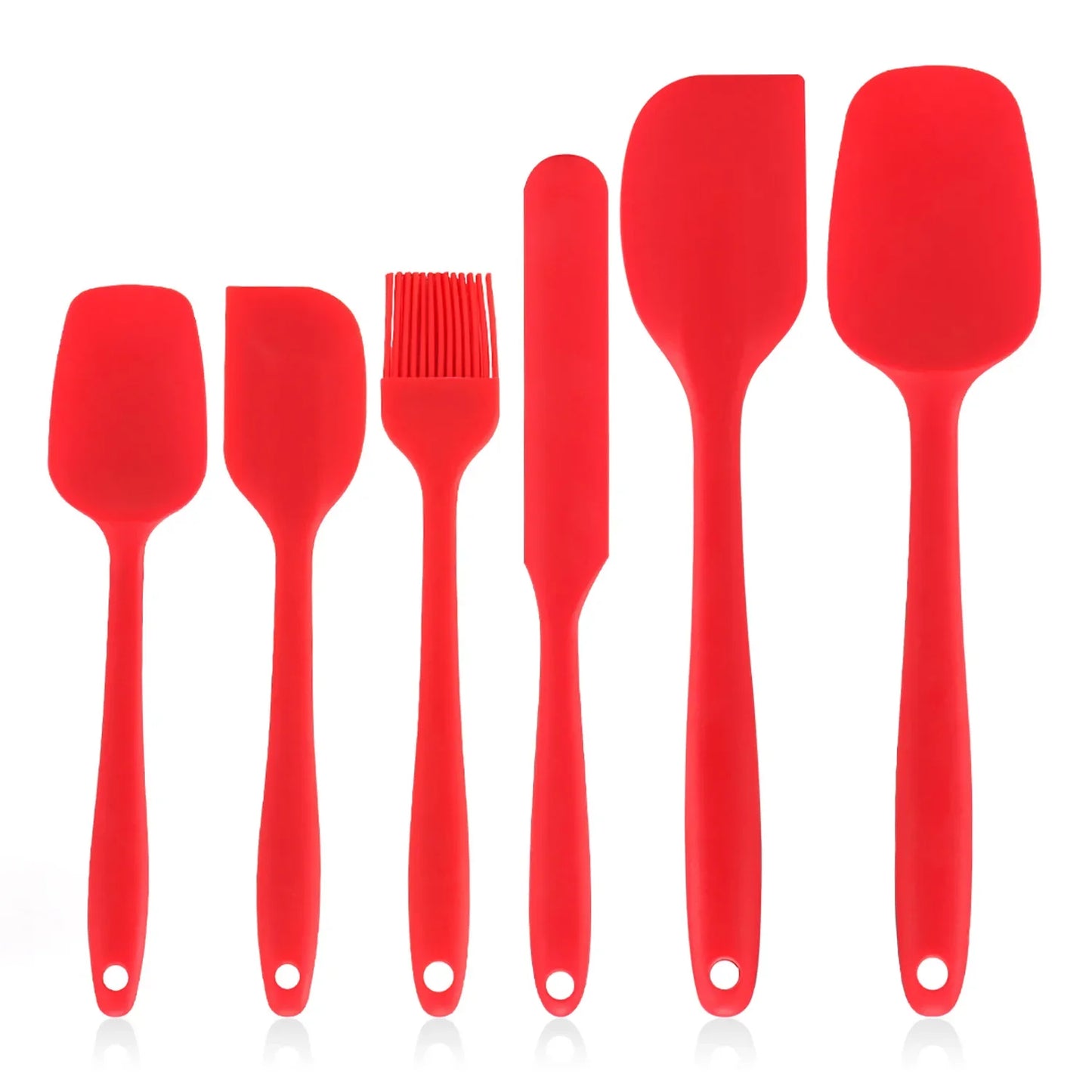 Set of red silicone kitchen utensils on a white background
