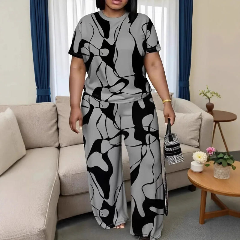 Woman in a black and white abstract patterned outfit standing in a living room.