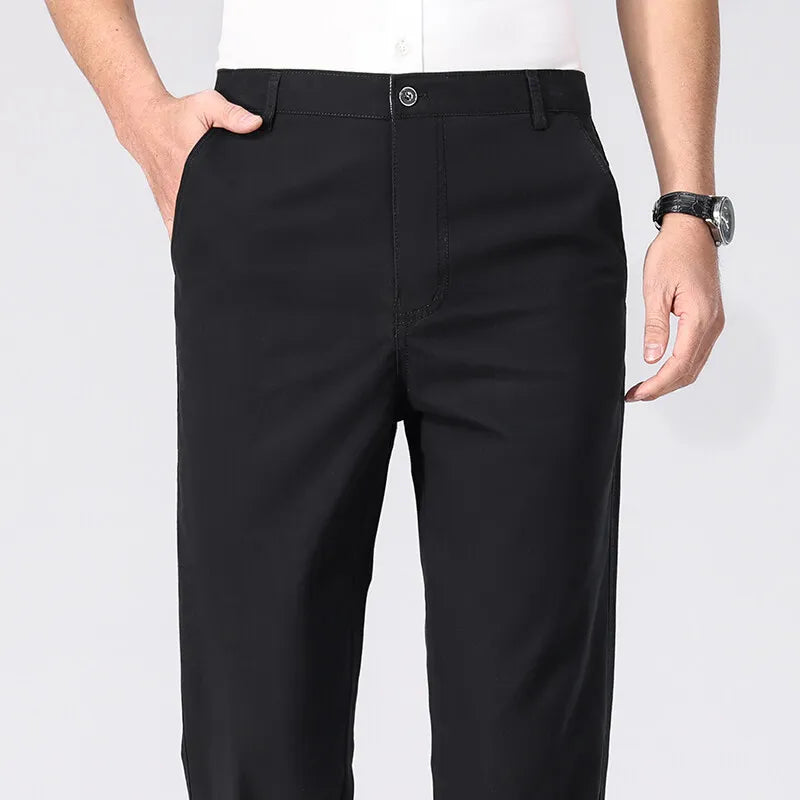 Black pants worn by a person on a white background