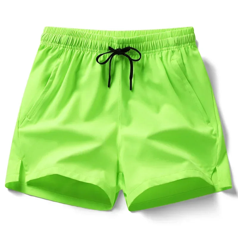 Neon green shorts with a drawstring on a white background