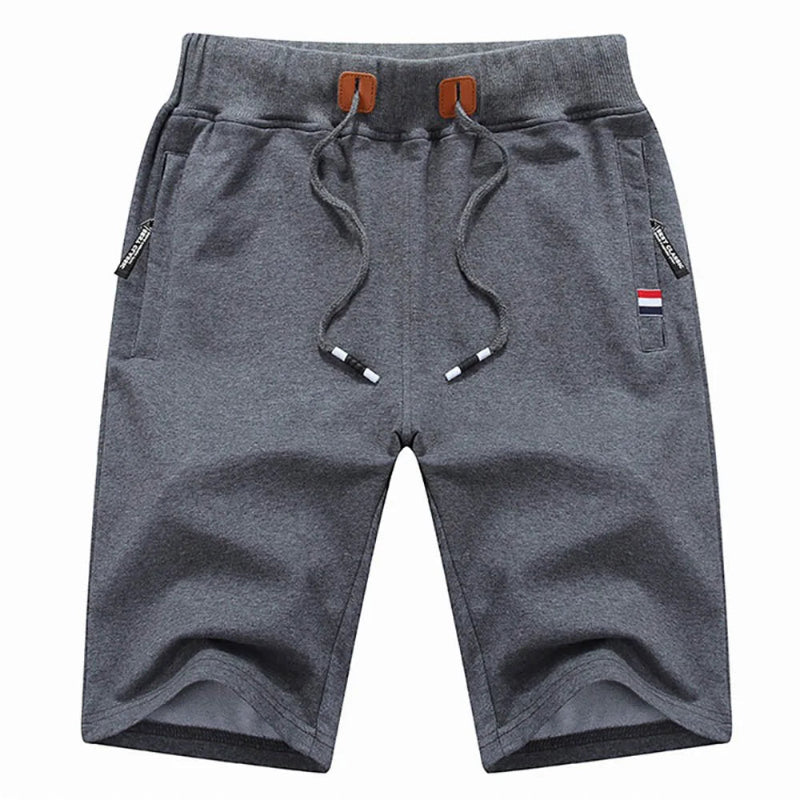 Gray shorts with drawstring and small flags on a white background