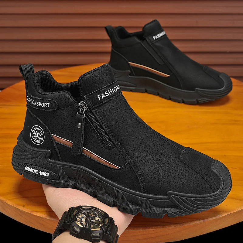Black boots with a zipper held by a hand on a wooden surface