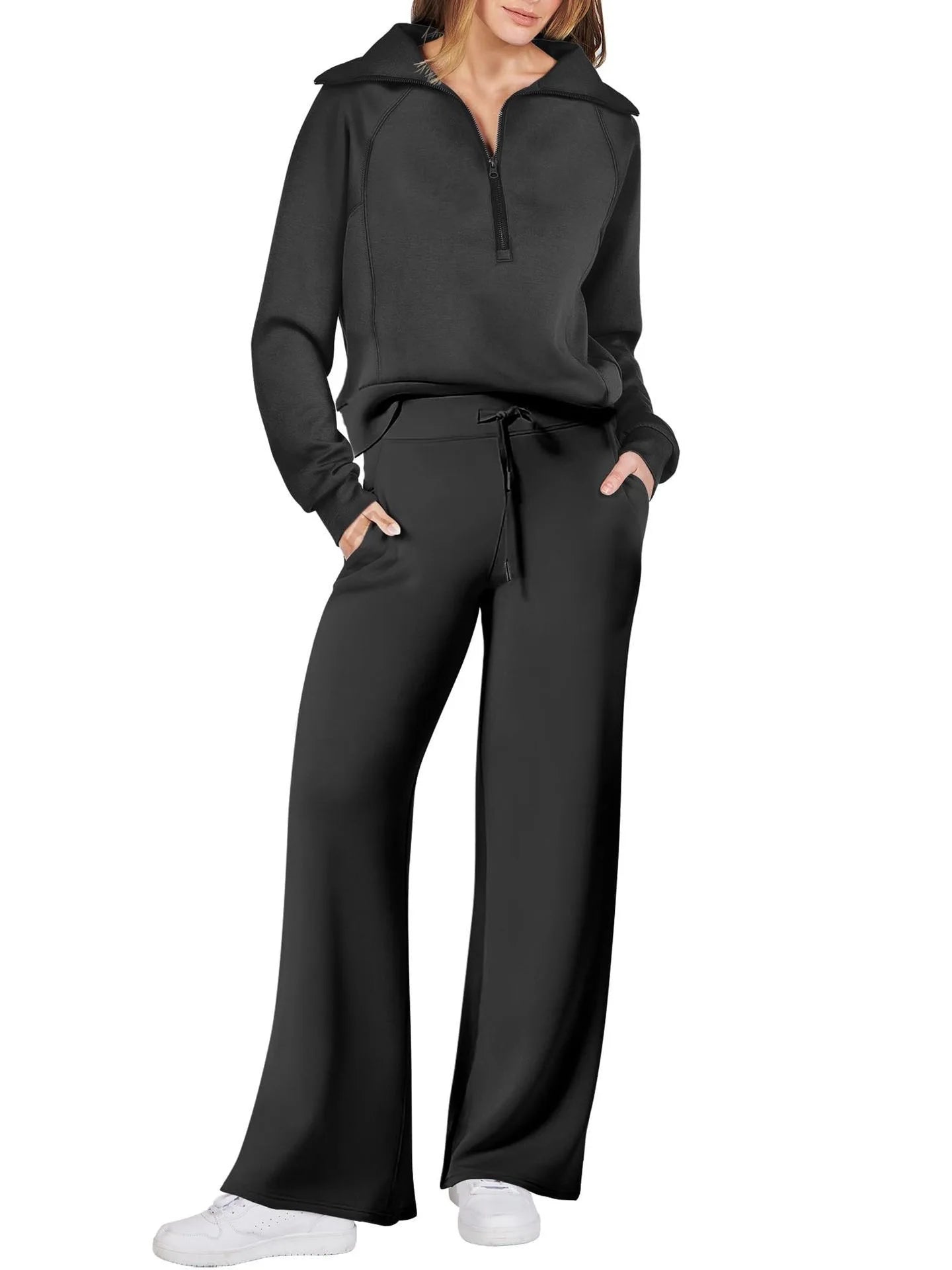 Person wearing a black tracksuit on a white background