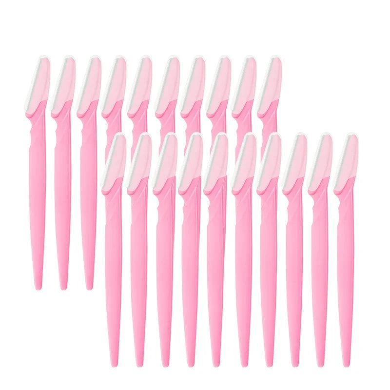 Set of pink and white makeup brushes on a white background