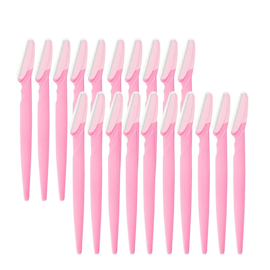 Set of pink and white makeup brushes on a white background