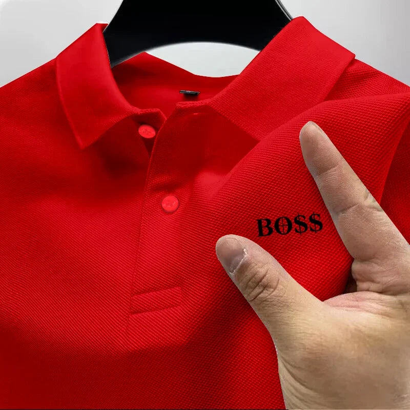 Red polo shirt with 'BOSS' embroidery on a hanger, held by a hand.