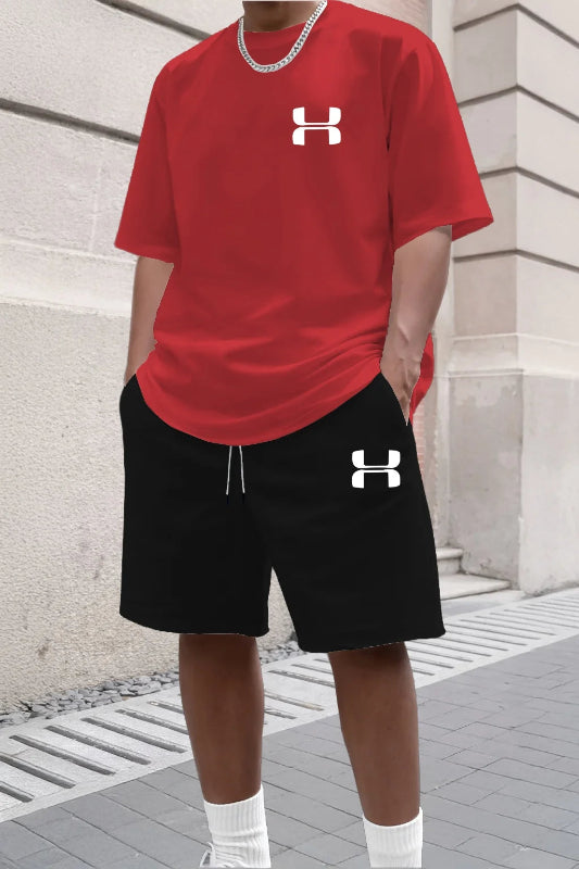 Person wearing a red Under Armour t-shirt and black shorts with the brand logo.