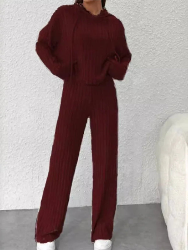 Burgundy sweater and pants set on a neutral background