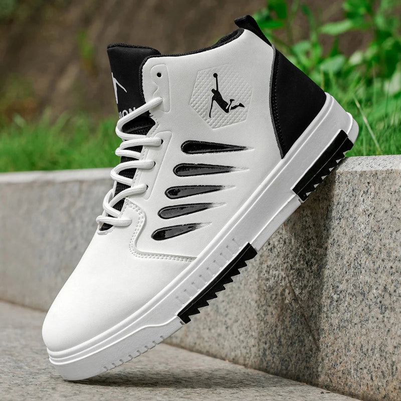White and black sneaker with a brand logo on a stone surface with greenery in the background