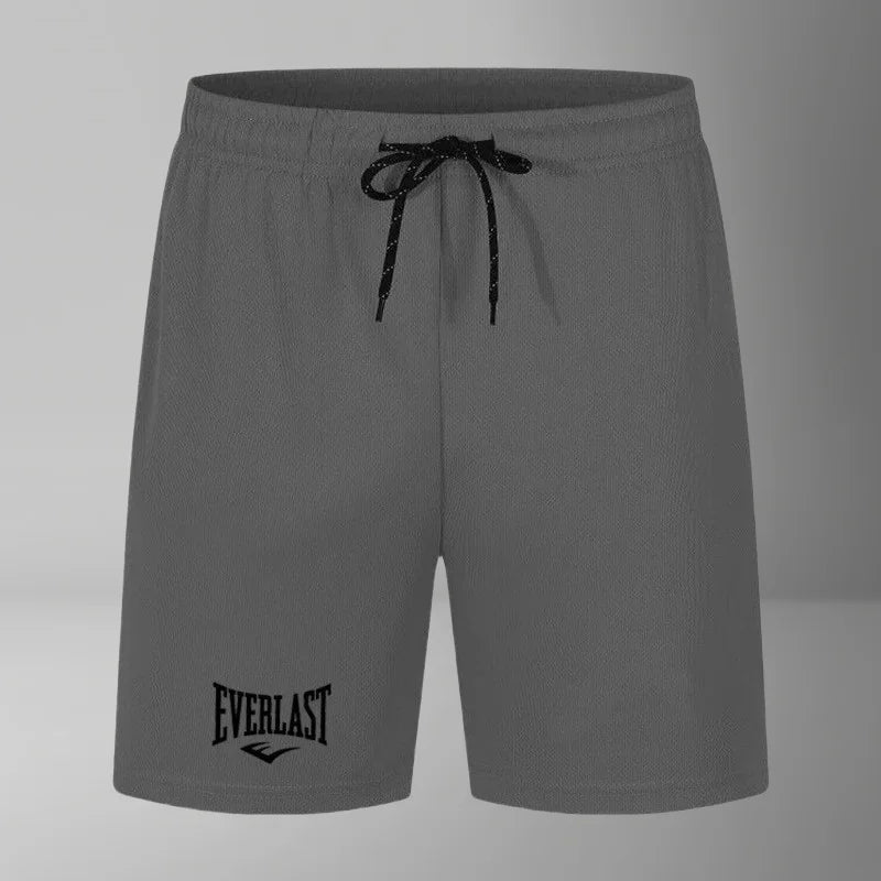 Gray shorts with a black drawstring and Everlast logo on a gray background