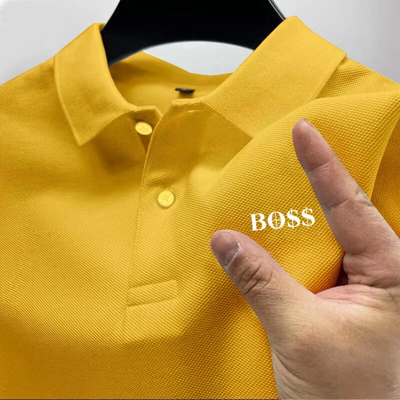 Yellow polo shirt with 'BOSS' logo on a hanger, finger pointing at the logo.