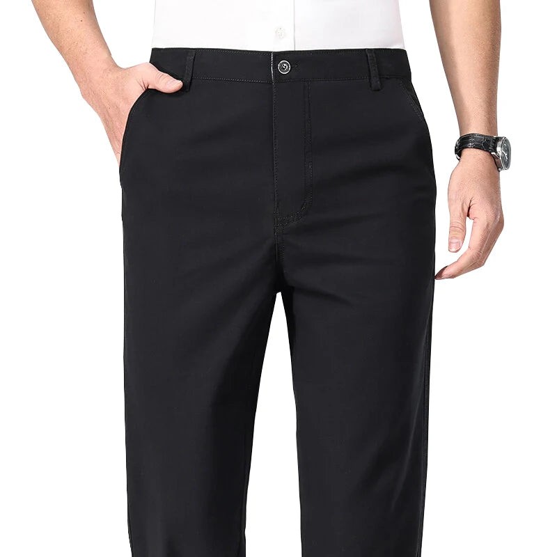 Black pants worn by a person on a white background