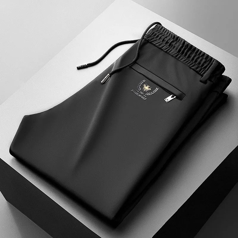 Black drawstring bag with a brand logo on a gray surface