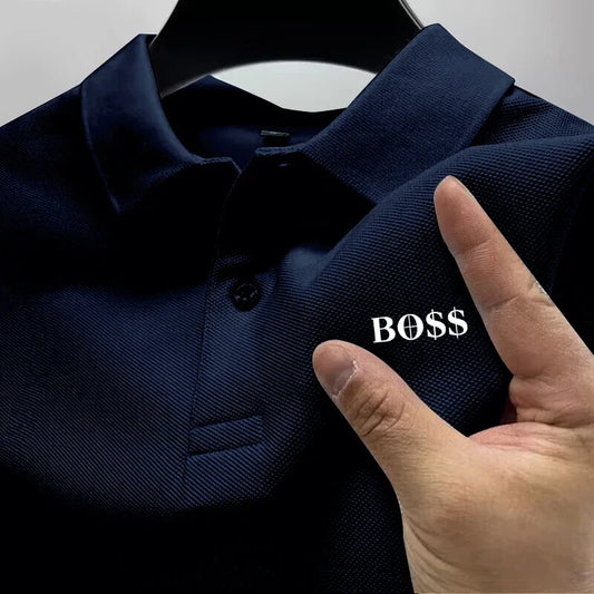 Navy blue polo shirt with 'BOSS' text on a hanger, hand pointing to the text.