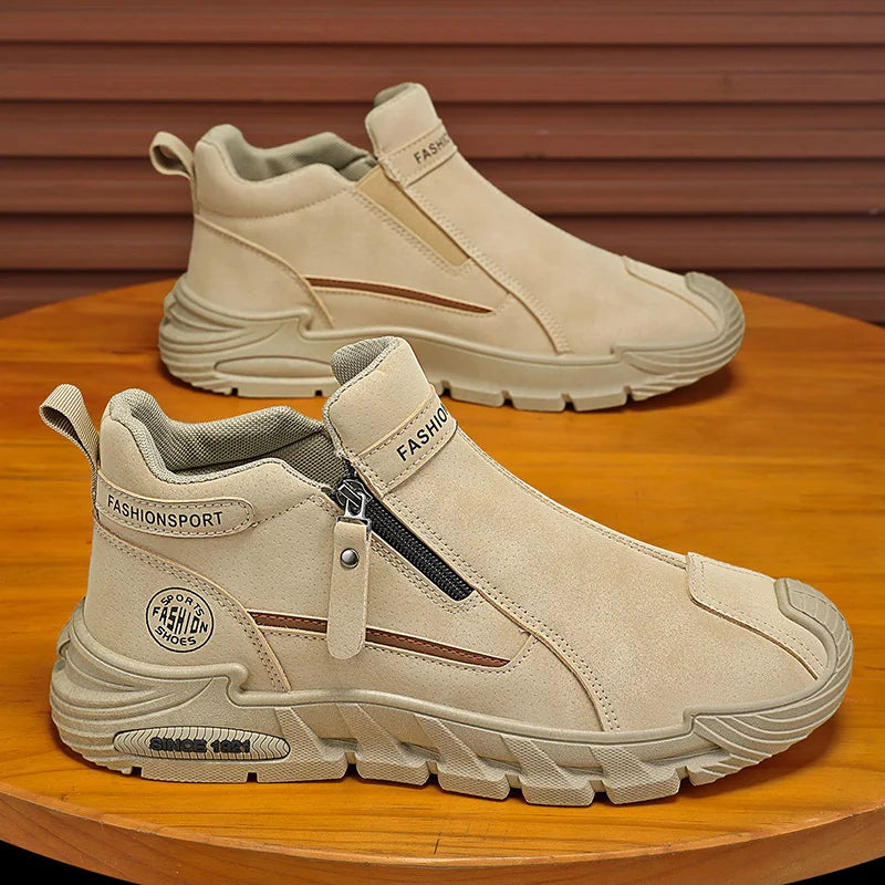 Beige slip-on shoes with zippers on a wooden surface