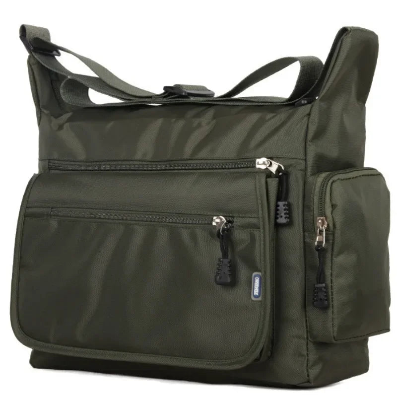 Green shoulder bag with multiple pockets and zippers on a white background