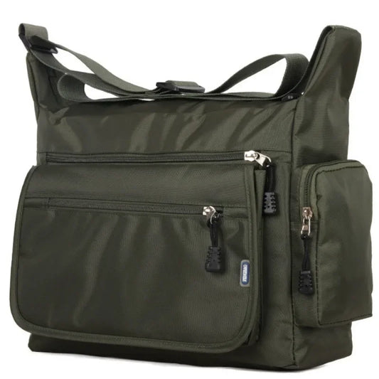 Green shoulder bag with multiple pockets and zippers on a white background
