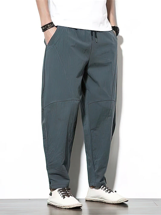 Person wearing gray pants on a white background