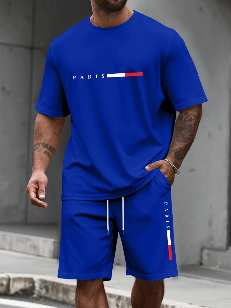 Person wearing a blue t-shirt and shorts set with 'PARIS' logo.