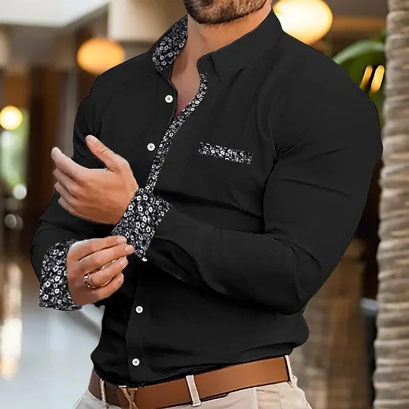 Man wearing a black shirt with sequin details in an indoor setting