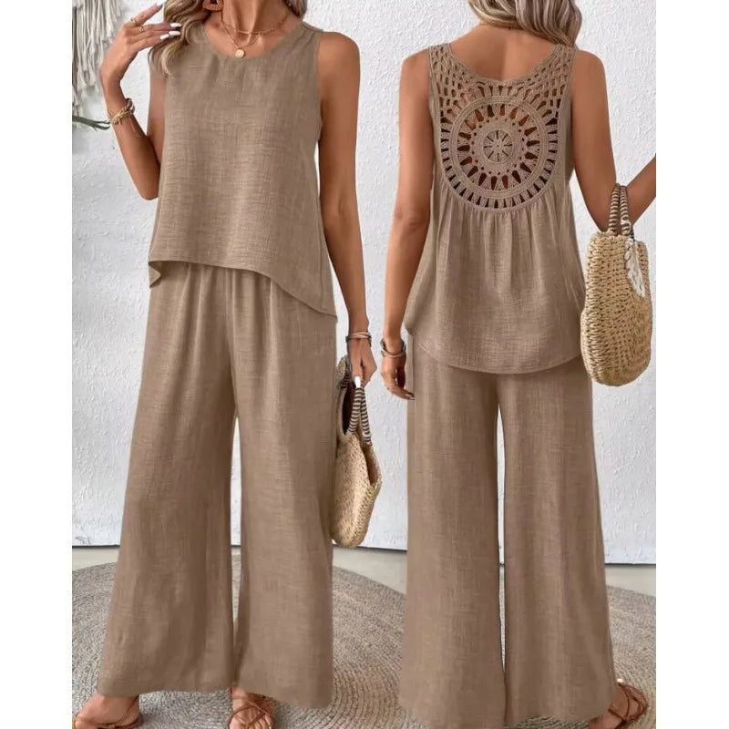 Woman wearing a beige sleeveless top and wide-leg pants with a textured back design, holding a straw bag.