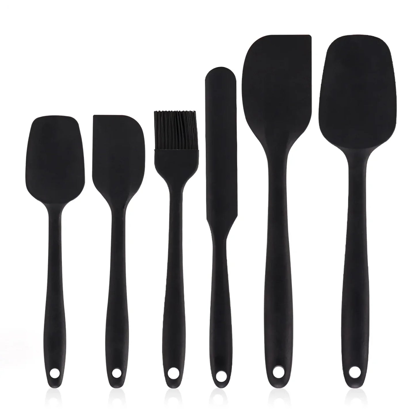Set of black silicone kitchen utensils on a white background