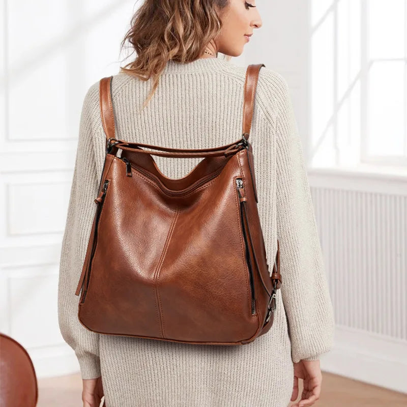 Woman wearing a brown leather backpack indoors