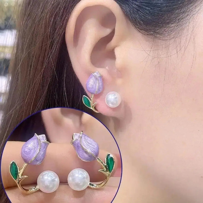 Close-up of an ear wearing a pair of earrings with purple and white stones.