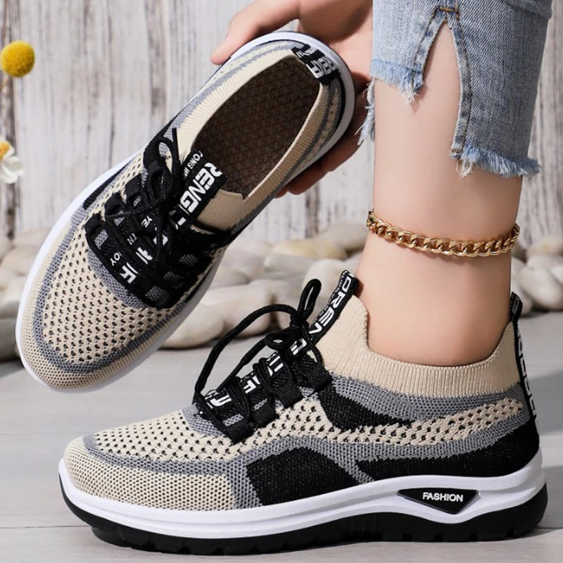 Person wearing black and beige sneakers with a neutral background