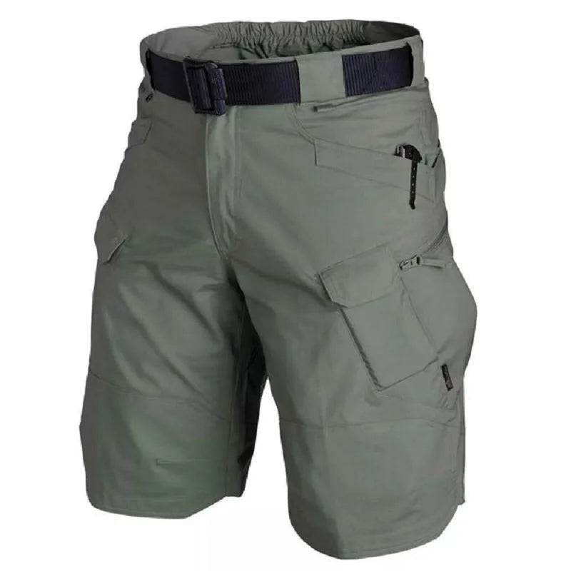 Green tactical shorts with multiple pockets and a belt on a white background