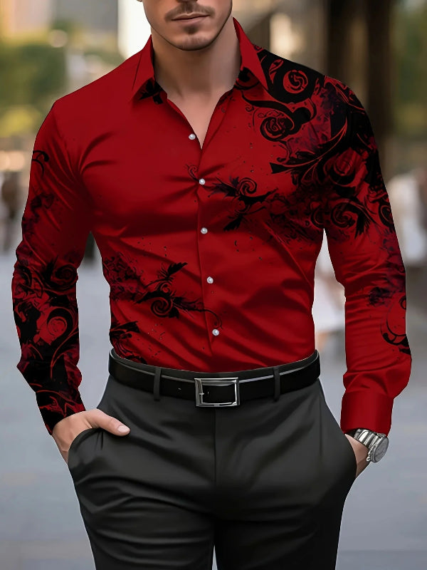 Man wearing a red shirt with black floral patterns and black pants.