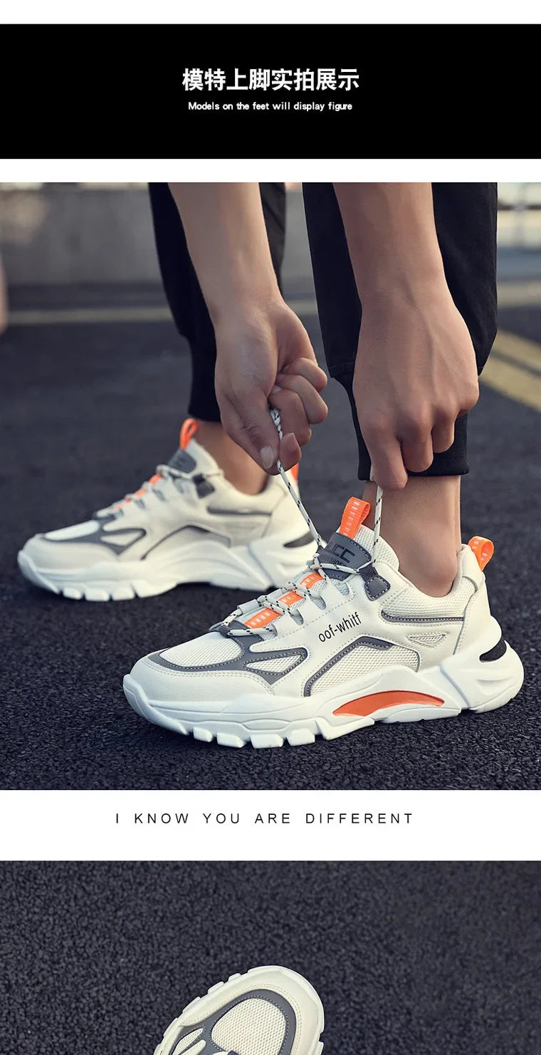 Person wearing white sneakers with orange accents, tying shoelaces on a blurred street background.