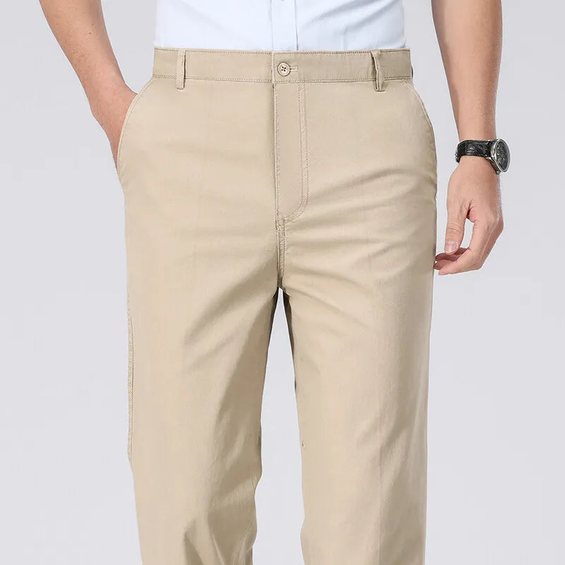 Beige pants worn by a person on a white background