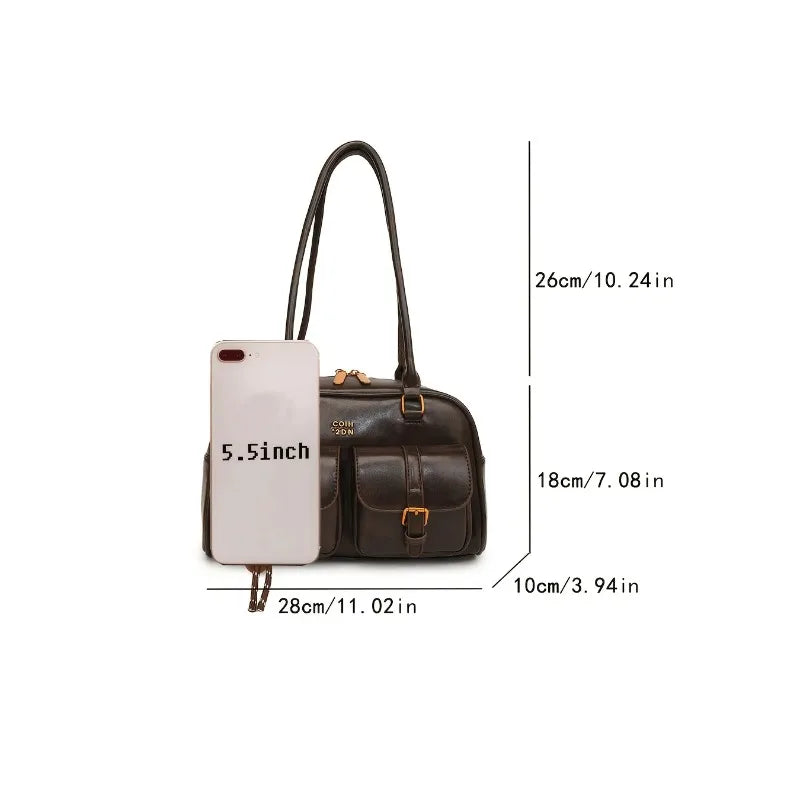 Measurement chart of a handbag with an included smartphone for scale on a white background