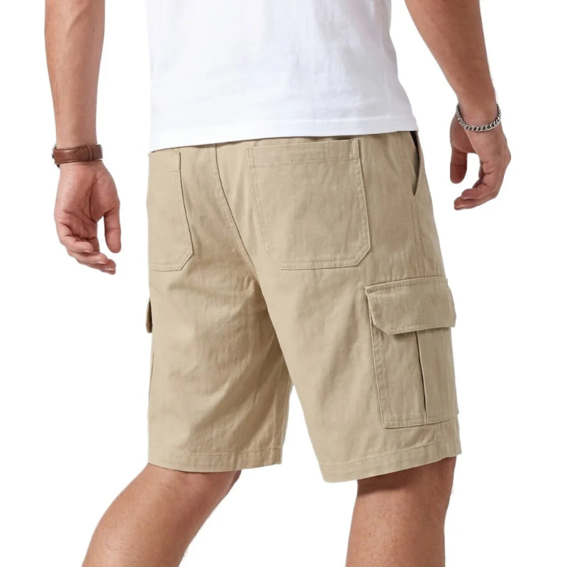 Beige cargo shorts worn by a person on a white background
