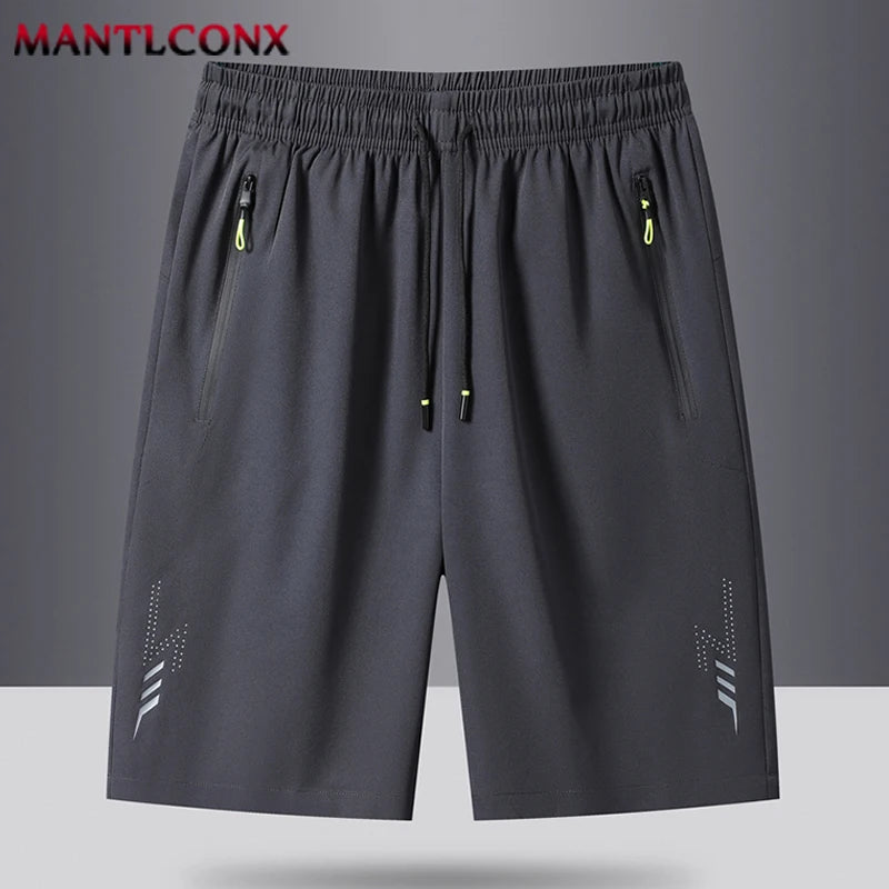 Gray shorts with drawstring and zippers on a gray background, featuring the brand 'MANTLCONX'.