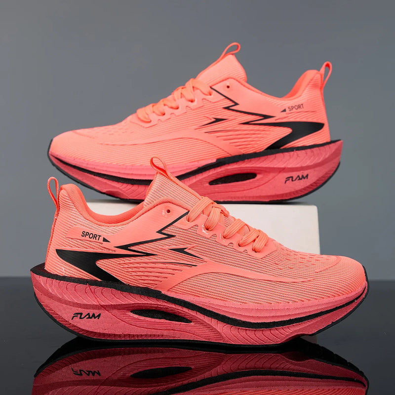 Pair of pink running shoes with black accents on a reflective surface and gray background