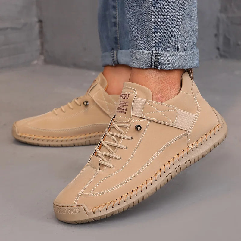 Beige leather shoes worn with rolled-up jeans on a neutral background