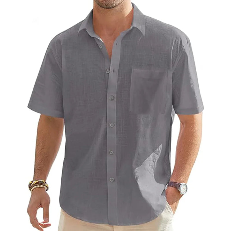 Man wearing a gray short-sleeve shirt on a white background