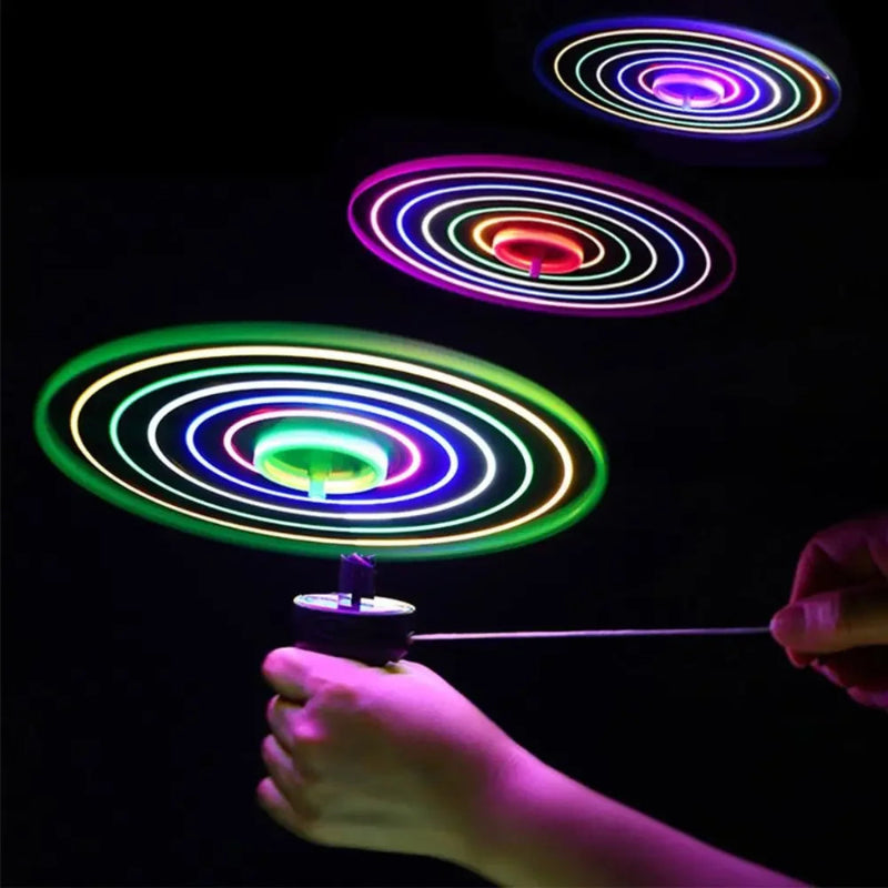 Colorful LED spinner toy being spun against a black background