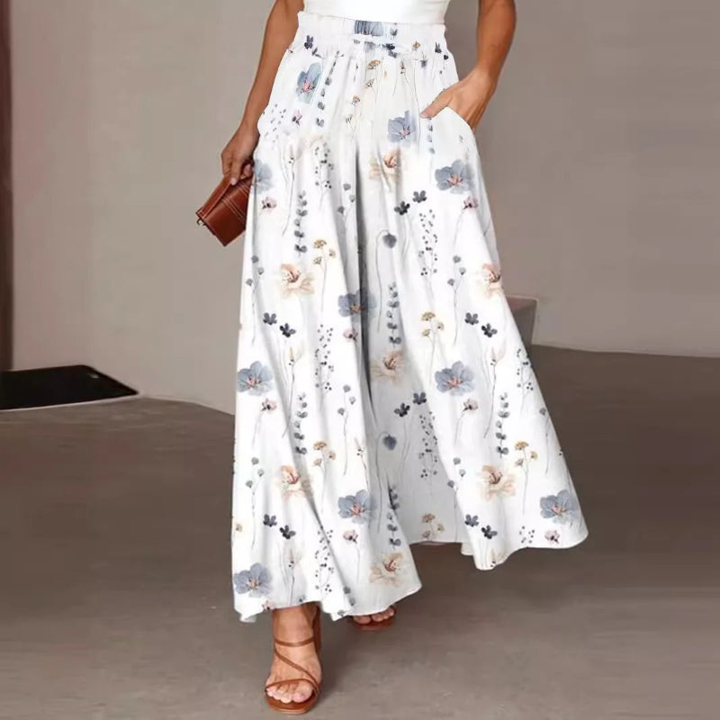 Person wearing a white floral dress on a neutral background
